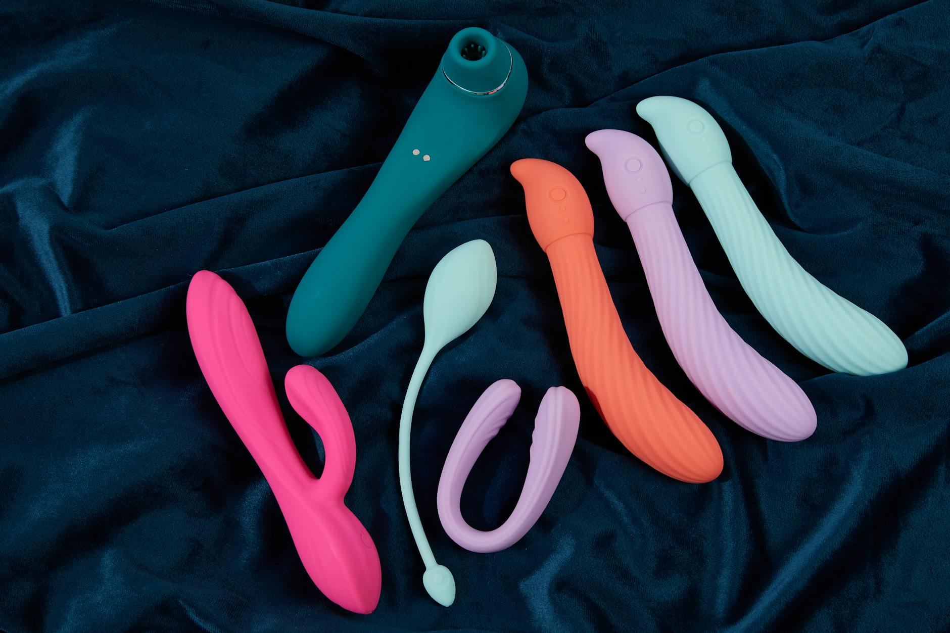 Young couple standing together indoors, holding a vibrator, symbolizing modern intimacy and reconnection