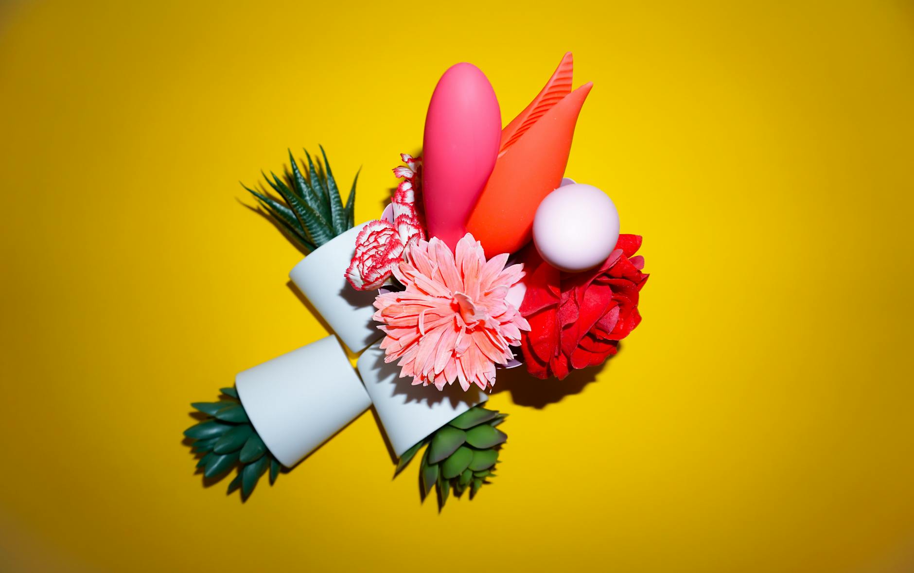 Person holding colorful vibrators, representing postpartum pleasure recovery options